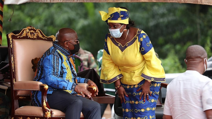 Cecilia Dapaah leaning over to talk to Akufo-Addo (seated).