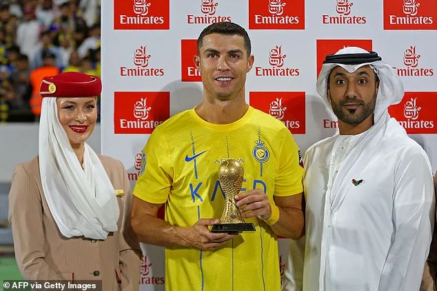 Christiano Ronaldo poses with officials after receiving man of the match award after a match in the Arab Champions Cup