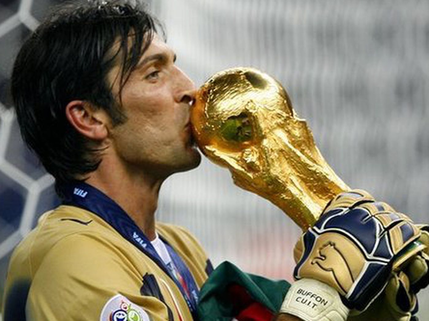 Gianluigi Buffon kisses the World Cup trophy after winning it with Italy in Germany in 2006