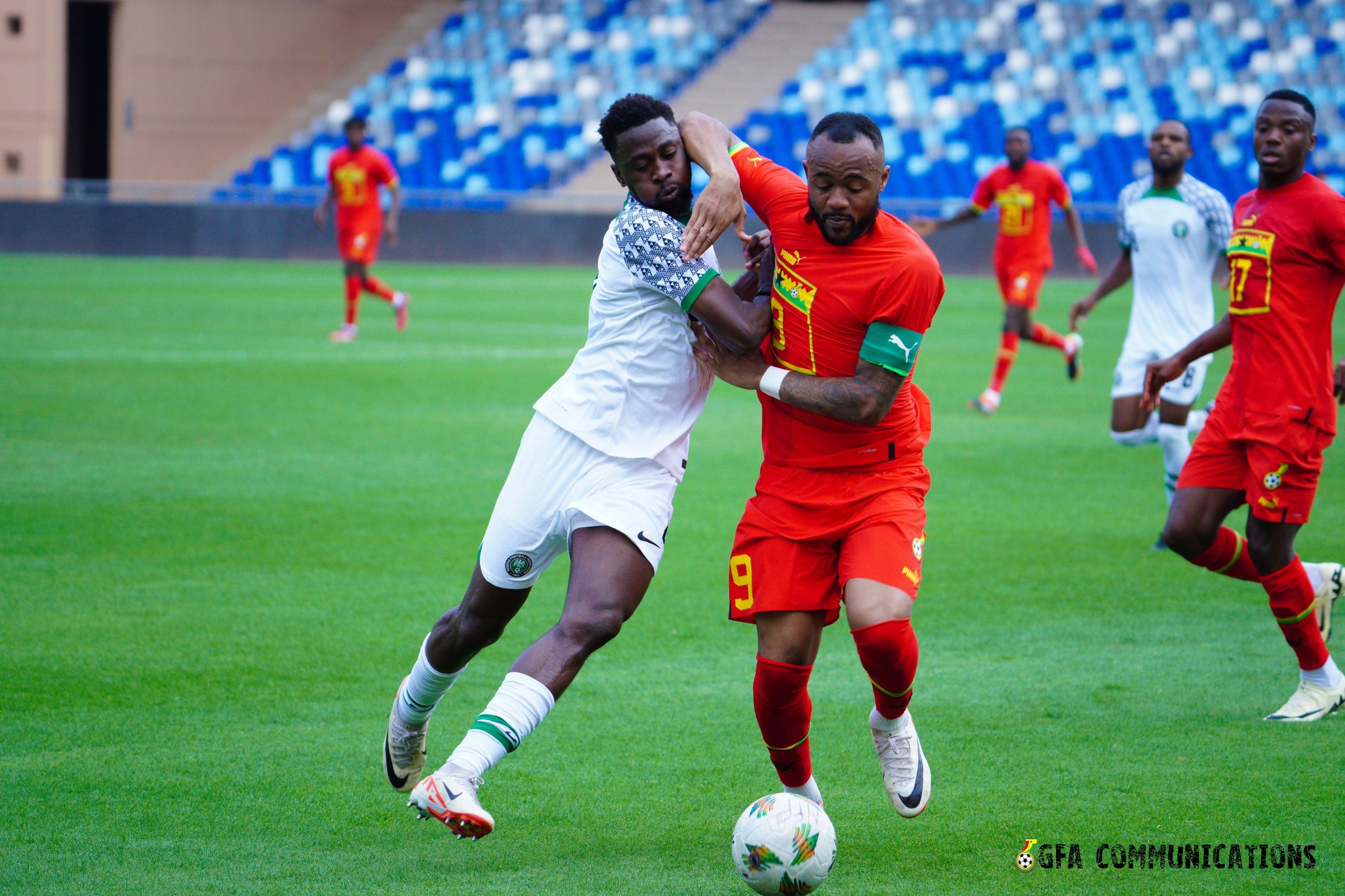 Jordan Ayew challenged by a Nigerian player during their friendly match at the Stade de Marrakech