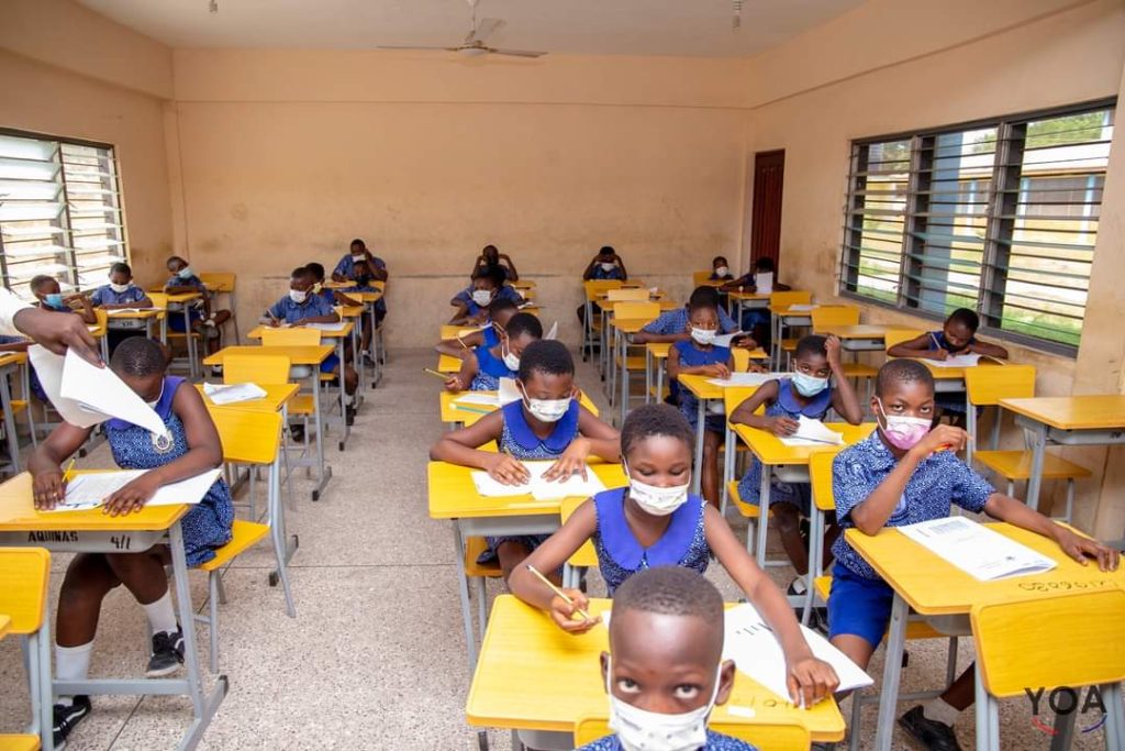 students writing exams. WAEC said they cannot pay off debts for BECE 2024