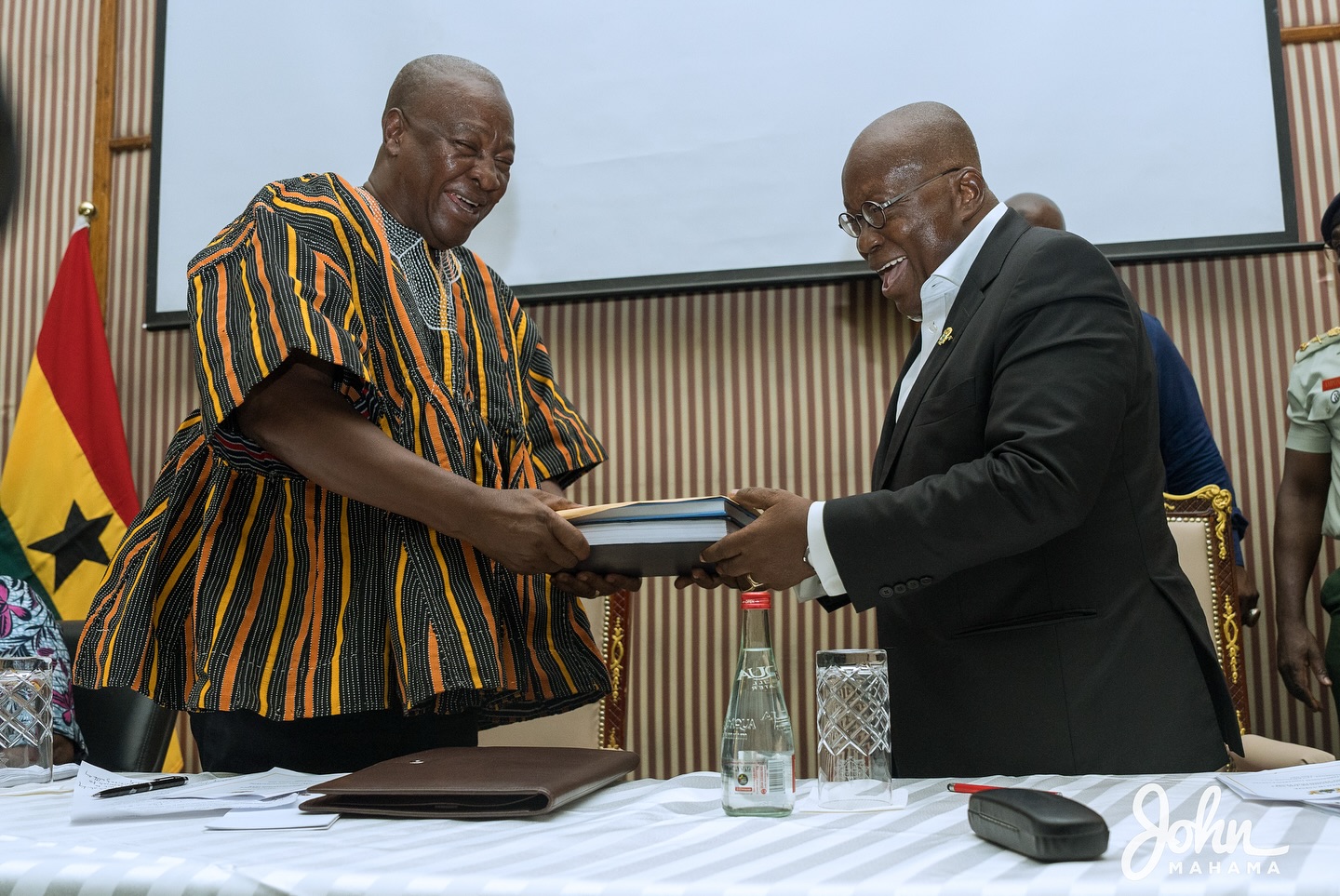 President John Mahama receives a document from Nana Akufo-Addo, former President